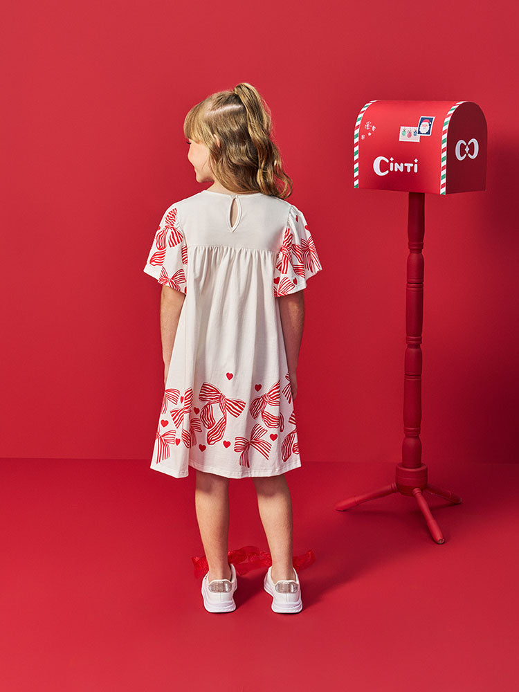 VESTIDO INFANTIL LISO COM ESTAMPA DE LACOS E CORACOES VERMELHOS NA MANGA E NA BARRA